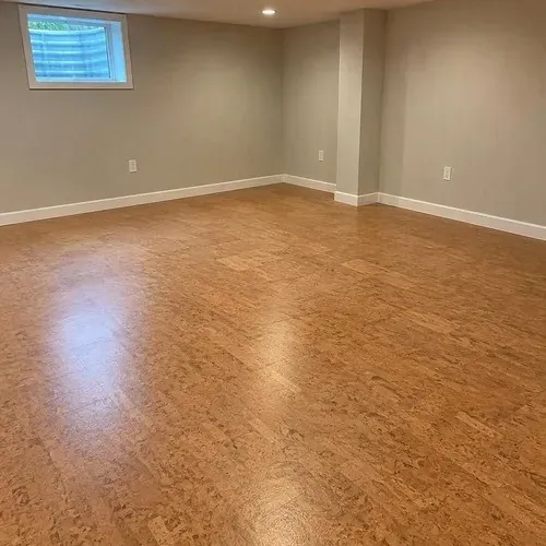 Warm matte cork flooring installed in a finished basement playroom
