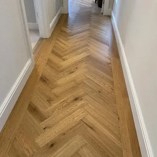 Two herringbone blocks meeting at a tight glue-down joint