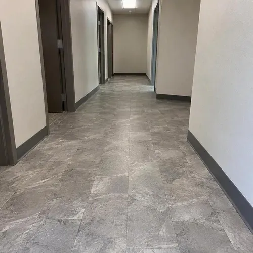 Commercial corridor with vinyl tile and cove base