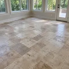 Tumbled travertine floor in a sunroom with natural colour variation