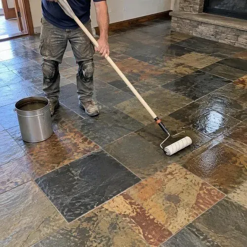 Penetrating sealer applied to a natural stone floor with a pole roller