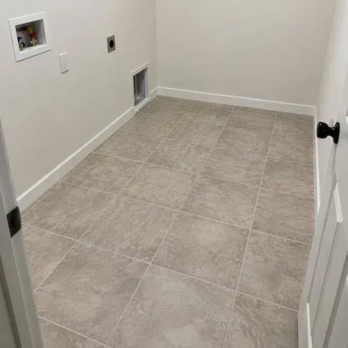 Finished square tile floor installed in a Kitchener laundry room